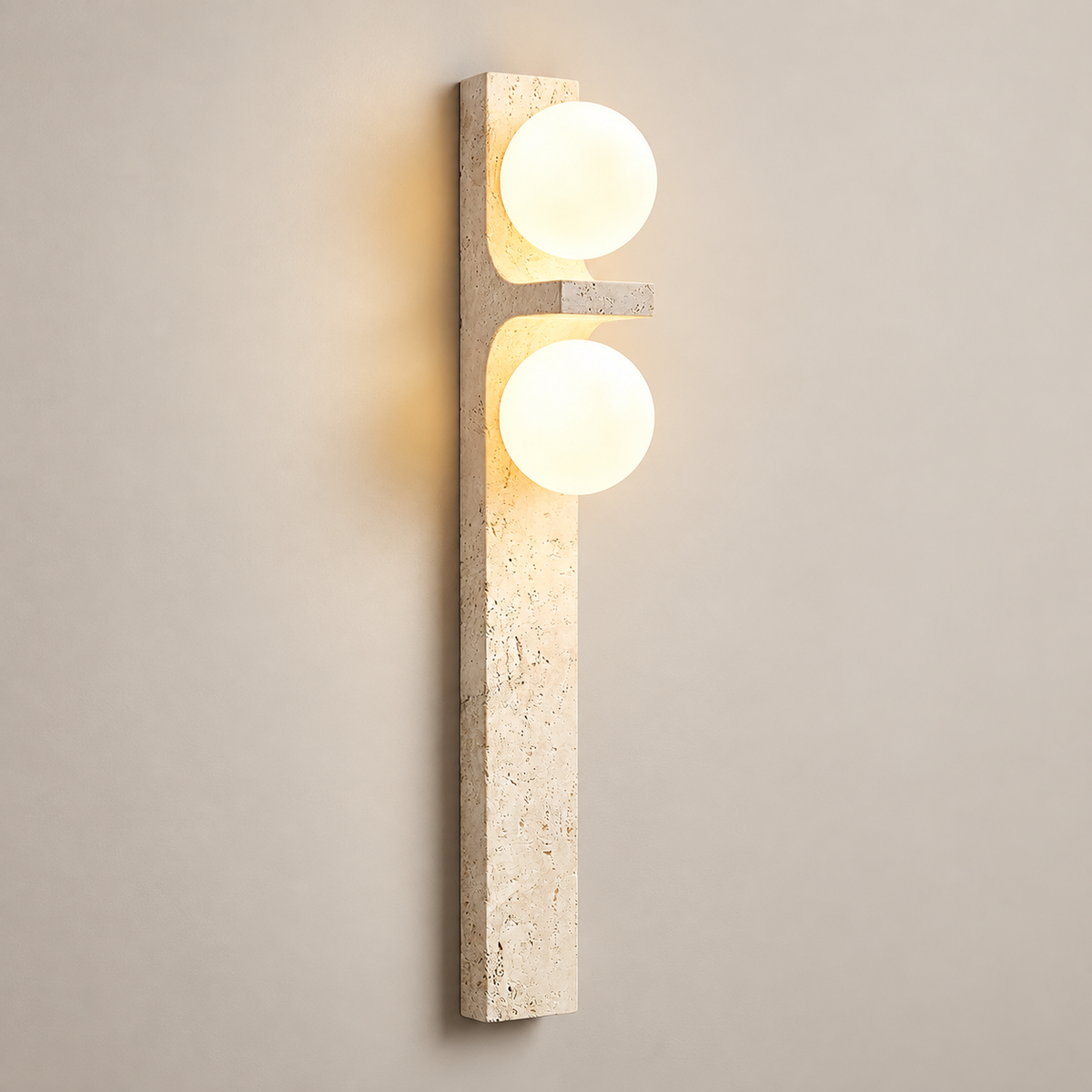 Asymmetrical Travertine Globe Wall Sconce on a warm greige background; Beige
