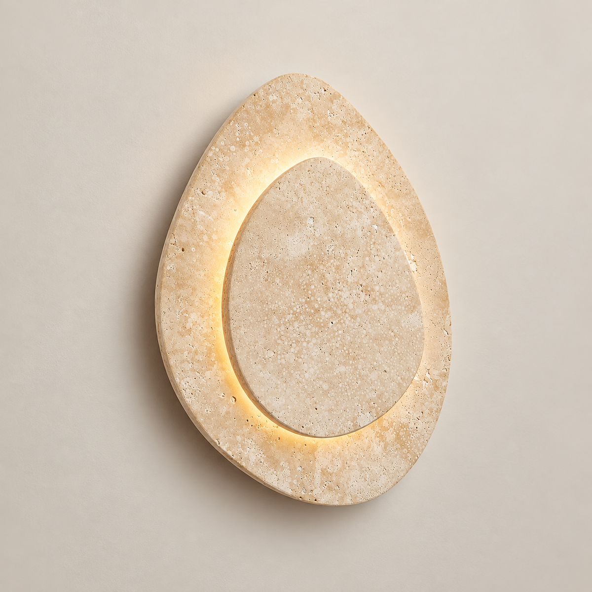 Alice Travertine LED Wall Sconce on a warm greige background; Beige