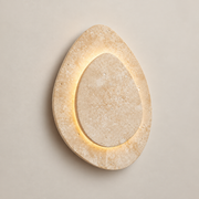 Alice Travertine LED Wall Sconce on a warm greige background; Beige