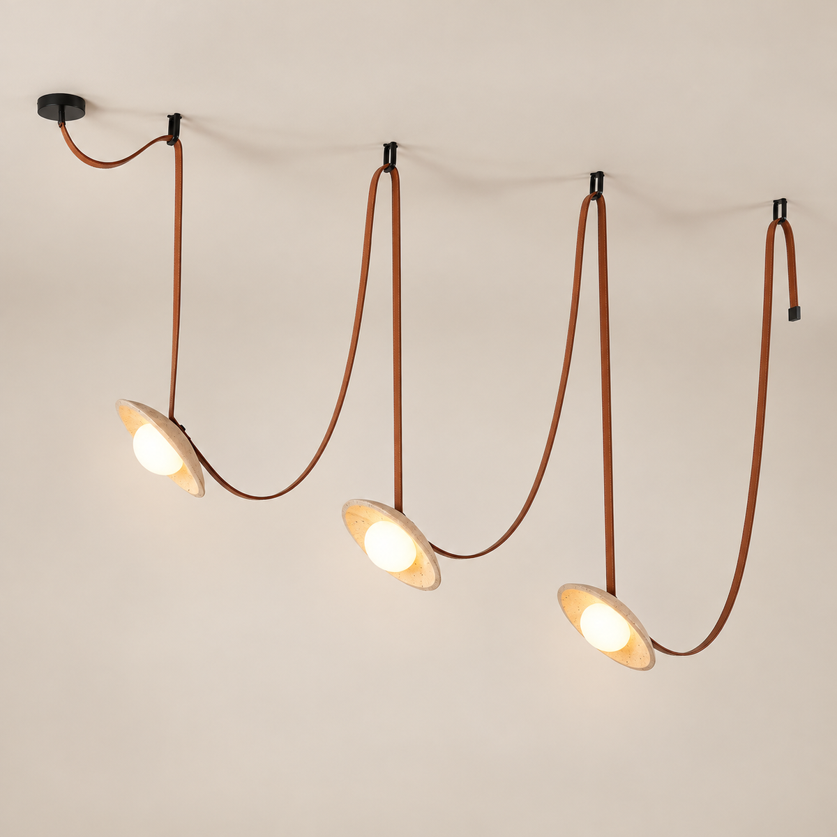 Light Rail Travertine Pendant Light with Leather Body on a warm greige background; Brown & Beige / 3 heads