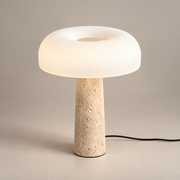 Carla Travertine Table Lamp on a warm greige background; Beige & White