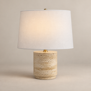Toby Japandi Travertine Table Lamp on a warm greige background; White drum shade beige cylindrical base