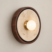 Dario Japandi Travertine Wall Sconce on a warm greige background; Walnut circular rim beige disk