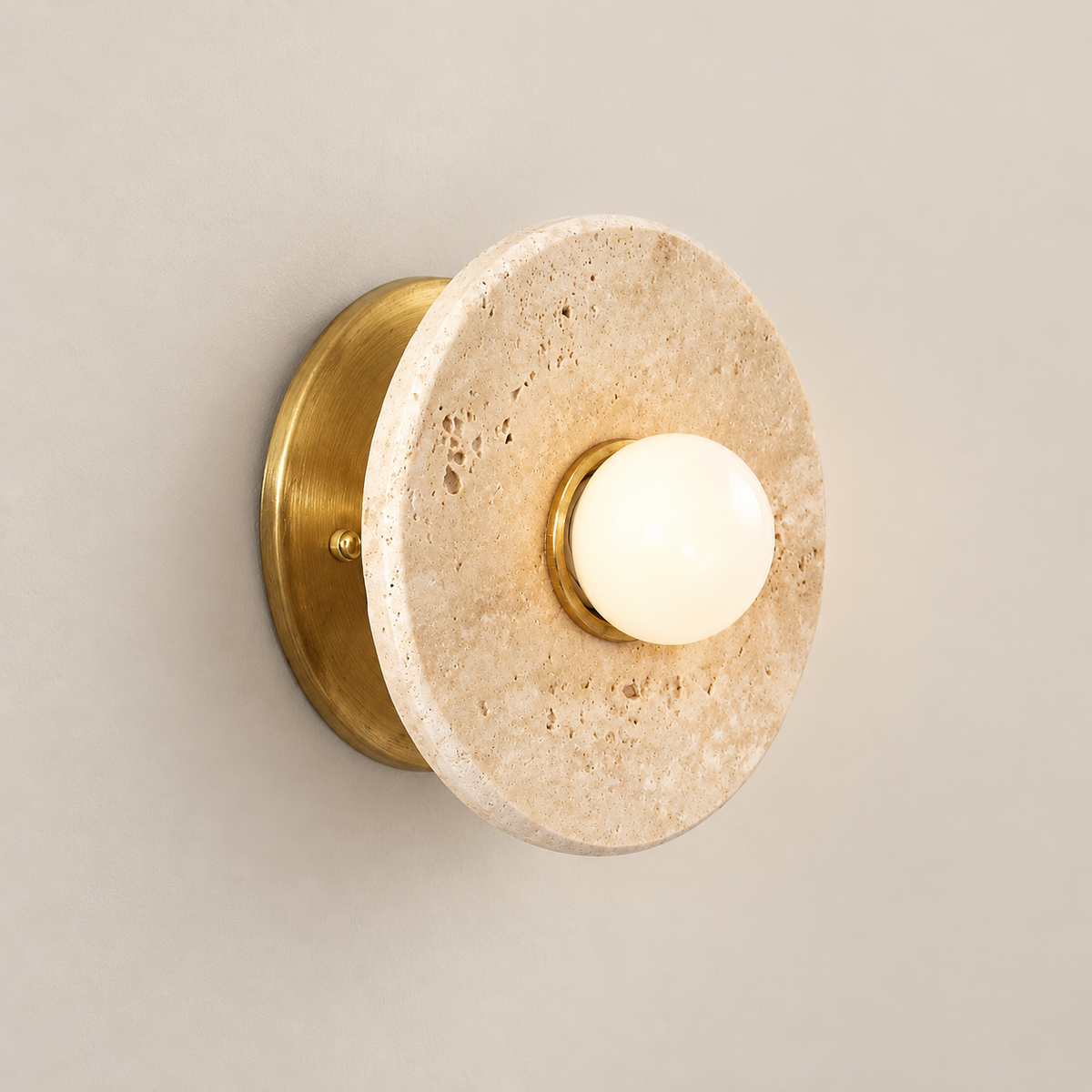 Haven Japandi Travertine Wall Sconce on a warm greige background; Beige disk brass wall backplate