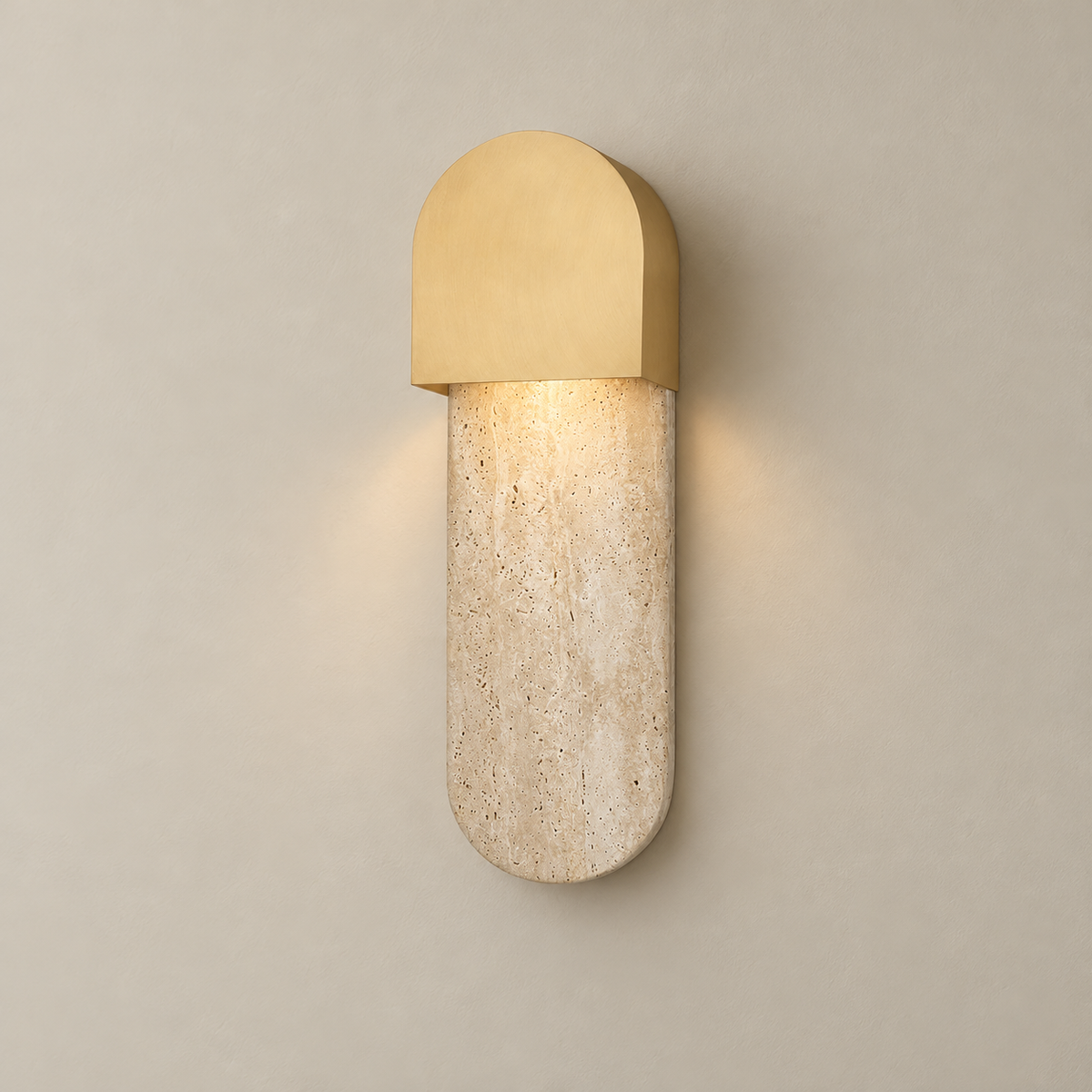 Hudson Travertine Wall Sconce on a warm greige background; Brass arch hood beige capsule