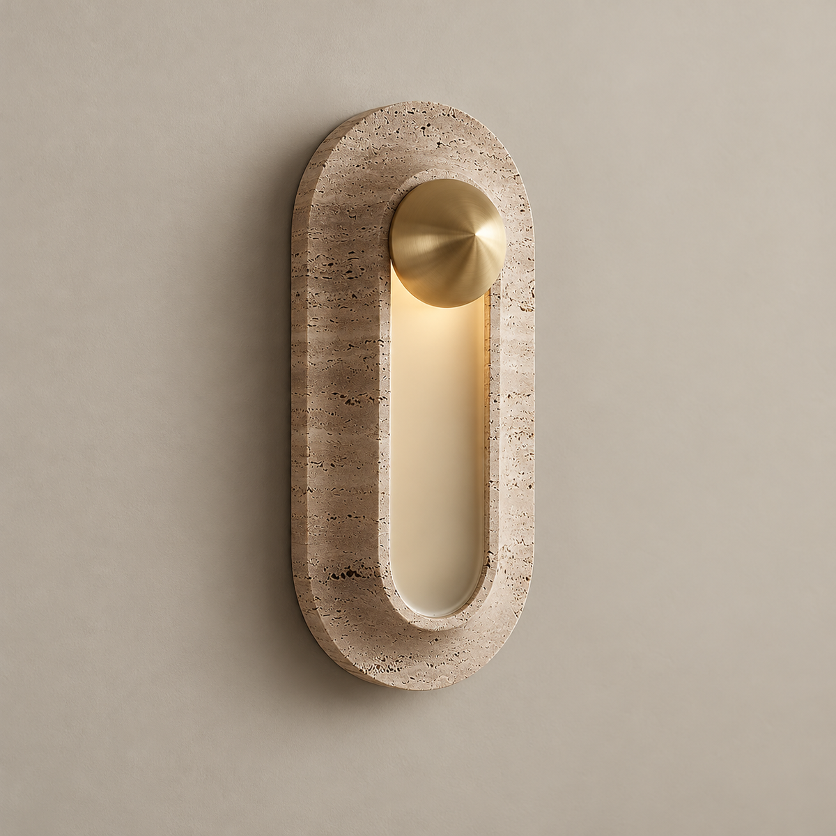 Pfaffikon Travertine LED Wall Sconce on a warm greige background; Brass top medallion travertine capsule frame