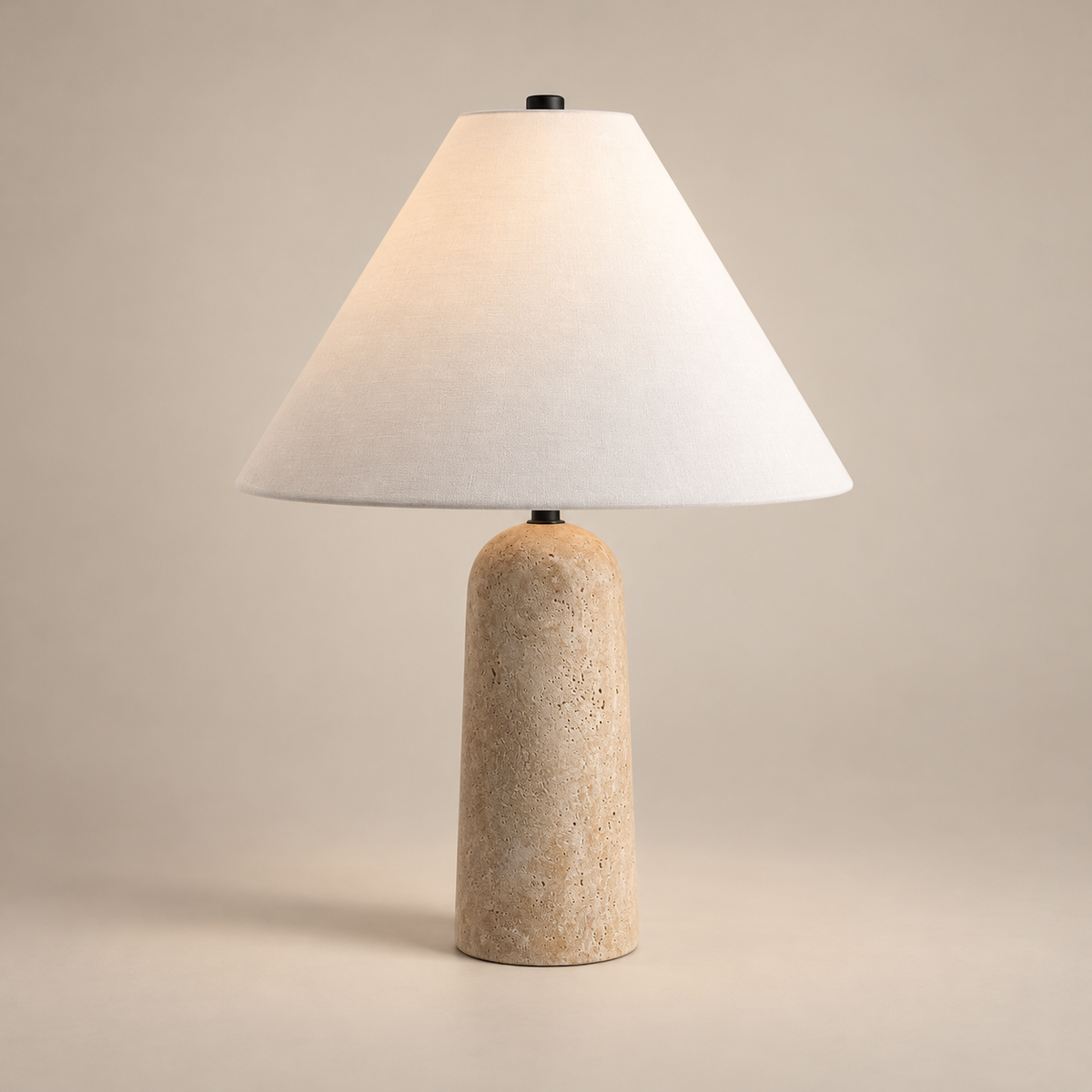 Astere Japandi Travertine Table Lamp on a warm greige background; Astere beige stone / white cone shade