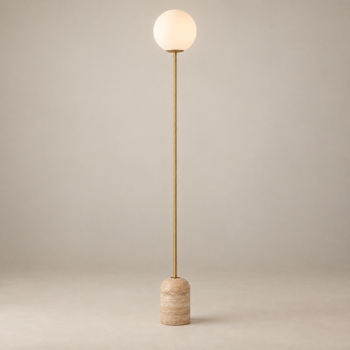 Aseneth Travertine Globe Floor Lamp on a warm greige background; Aseneth gold stem / beige stone / white globe