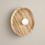 Celeste Japandi Travertine Wall Sconce on a warm greige background; Celeste beige round dish / small white globe