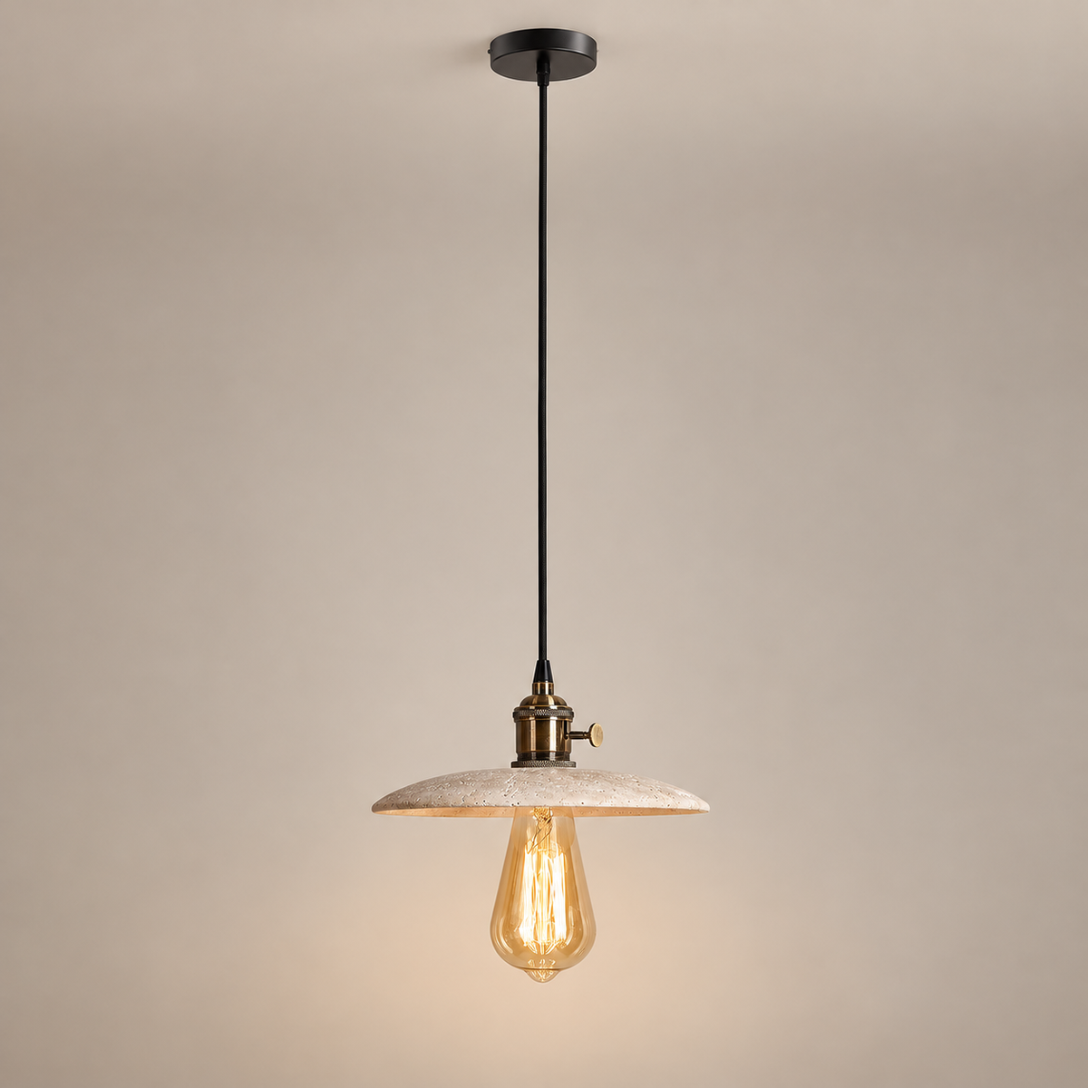 Brooklyn Flat Travertine Pendant Light on a warm greige background; Brooklyn flat beige saucer / brass / long black cord
