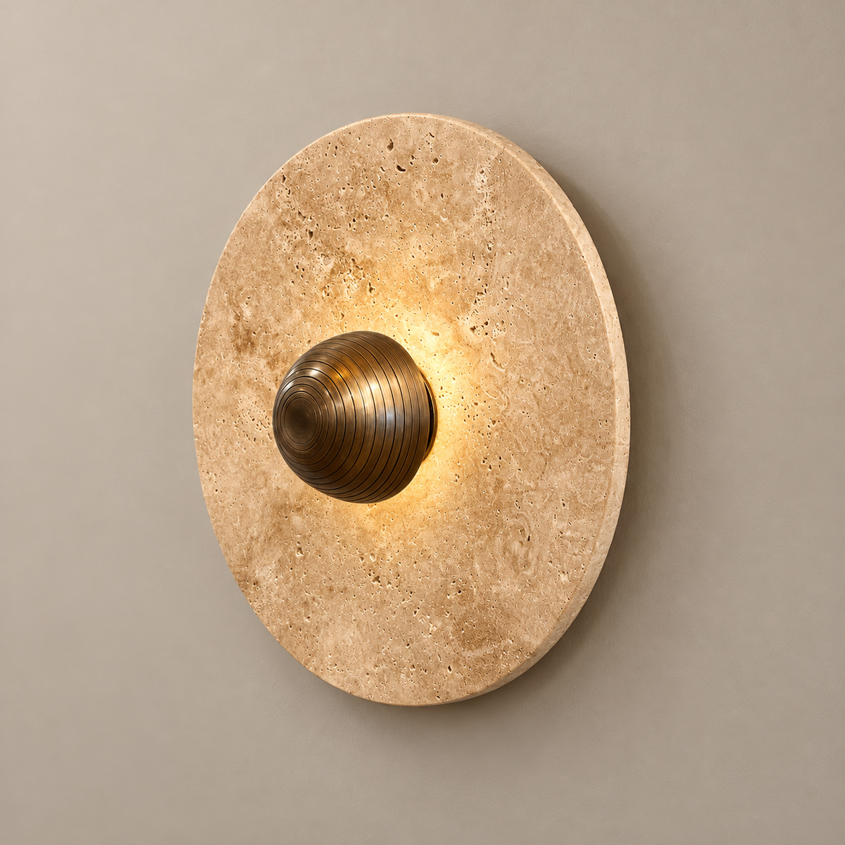 Alese Travertine LED Wall Sconce on a warm greige background; Alese beige disk / concentric bronze center dome