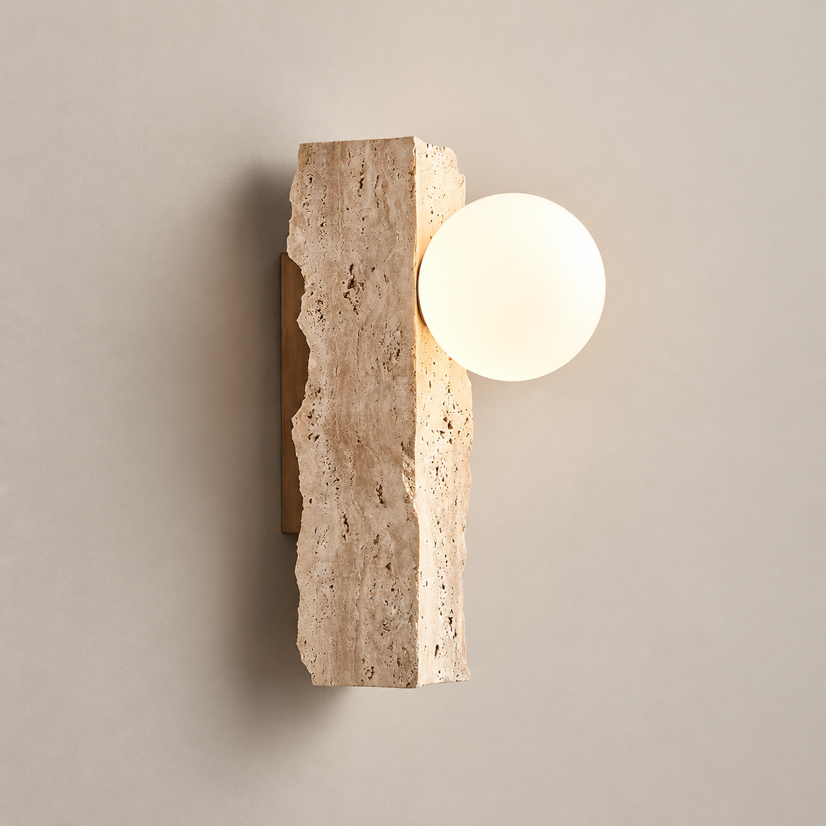 Aureum Travertine Globe Wall Sconce on a warm greige background; Beige rough cruciform stone, white globe