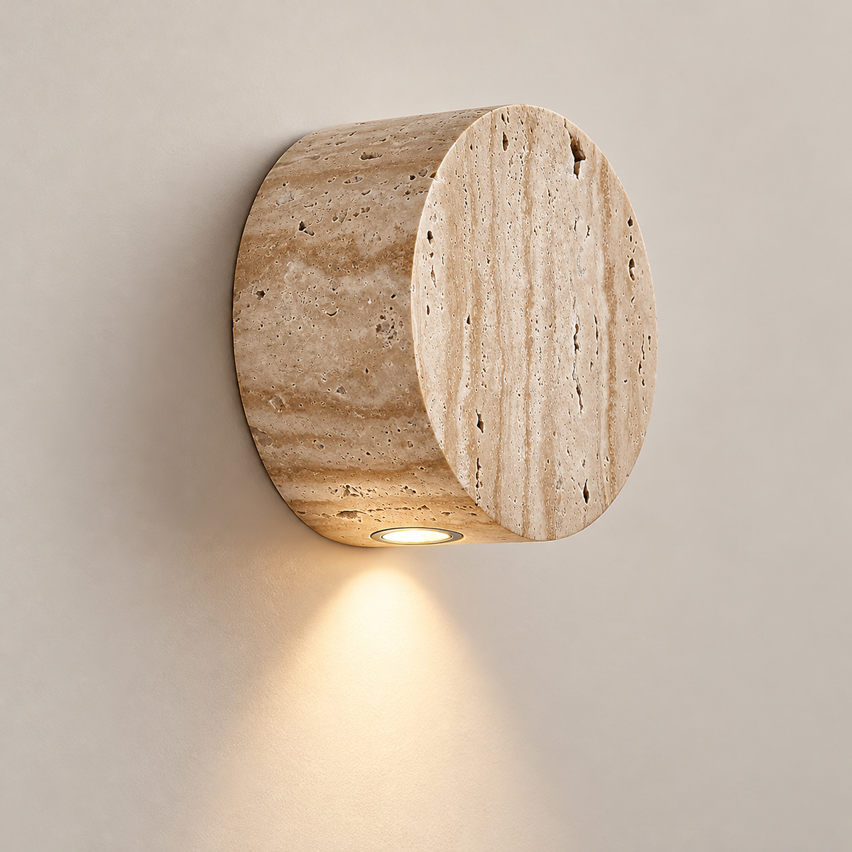 Troia Japandi Travertine Wall Sconce on a warm greige background; Beige stone downward spot