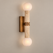 Bellini Travertine Globe Wall Sconce on a warm greige background; Beige stone, vintage brass and two white globes