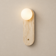 Lia Japandi Travertine Wall Sconce on a warm greige background; Beige long capsule and globe