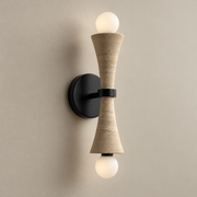 Dax Travertine Wall Sconce on a warm greige background; Beige travertine and black metal