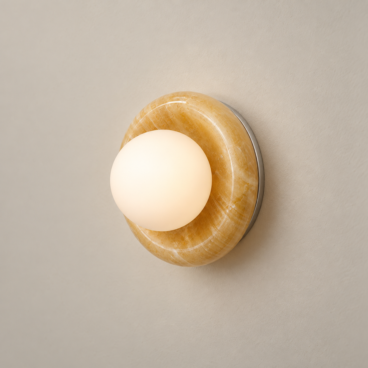 Novi Organic Modern Onyx Wall Sconce on a warm greige background; Yellow onyx and white globe