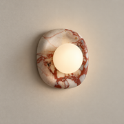Orli Square Onyx Wall Sconce on a warm greige background; Red veined onyx and white glass
