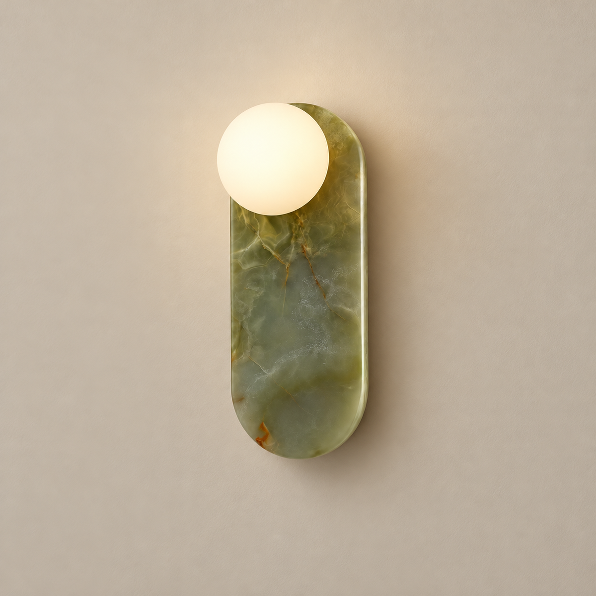 Lucie Organic Modern Onyx Wall Sconce on a warm greige background; Green cyan onyx and white globe