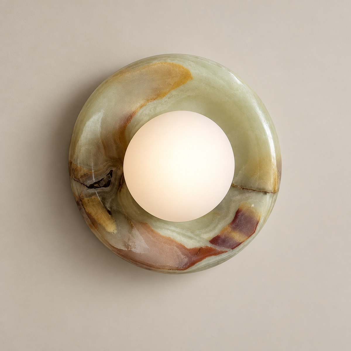 Orli Cyan Onyx Globe Wall Sconce on a warm greige background; Cyan onyx and white globe