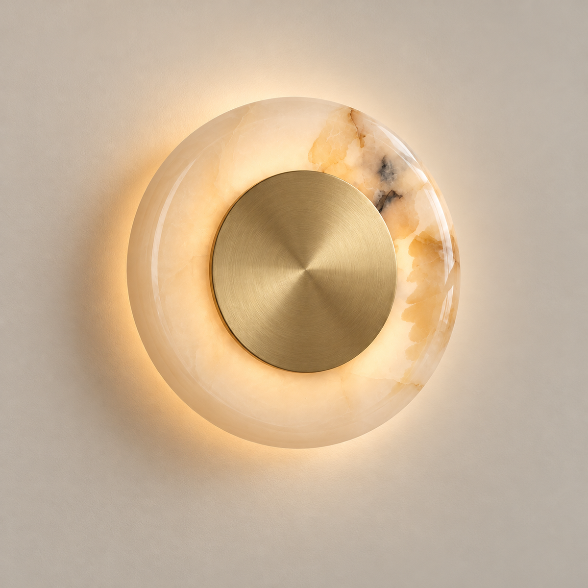 Ethereal Moon Onyx LED Wall Sconce on a warm greige background; White onyx and brushed brass disk