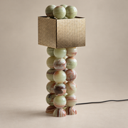 Atalaya Onyx LED Table Lamp on a warm greige background; Atalaya green onyx, polished engraved brass cube