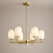 Alana Geometric Onyx Chandelier on a warm greige background; Alana six-light brass chandelier