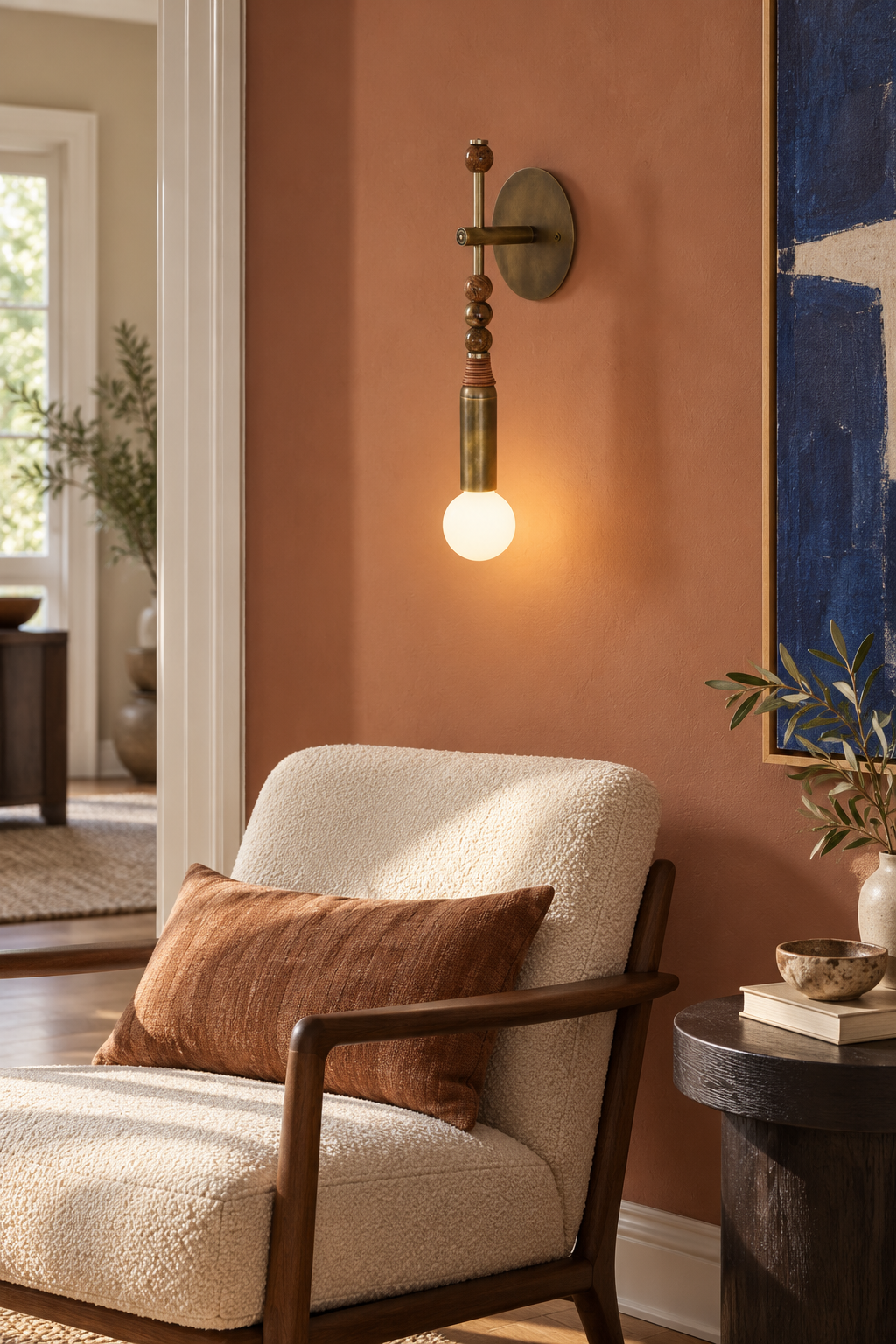 Toam brass wall sconce with brown marble beads in a bright lounge, light on