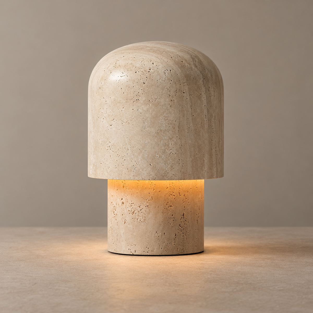 Kennett beige travertine table lamp on a warm taupe surface