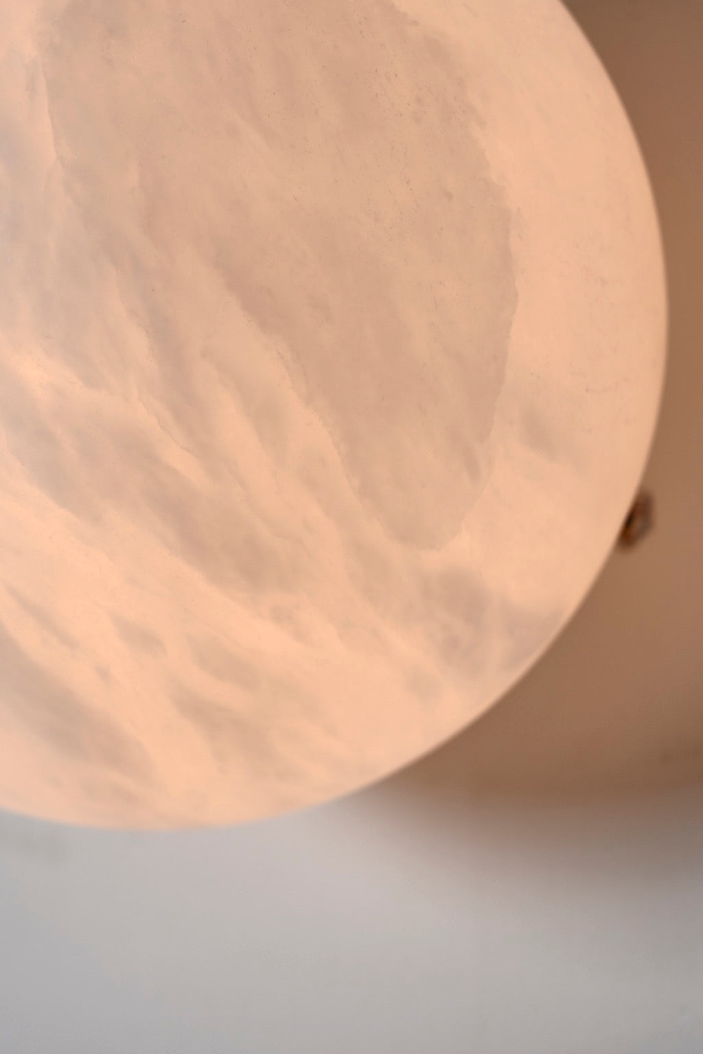 Real close-up of illuminated alabaster veining and the curved shade edge