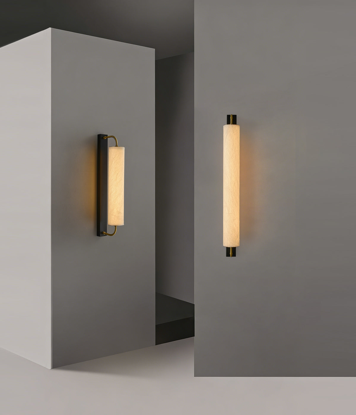 Small and large mulberry silk cylinder wall sconces on gray walls