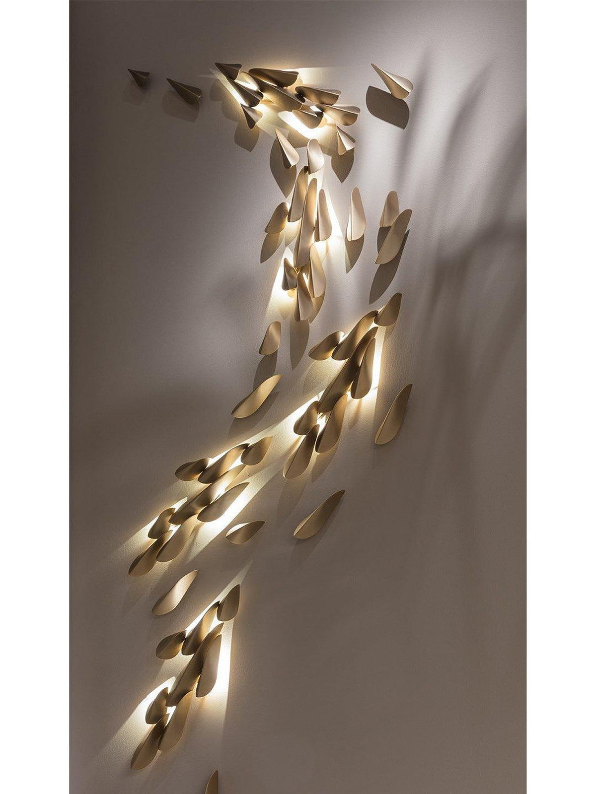 1273 large brass leaf wall light warm wall projection detail