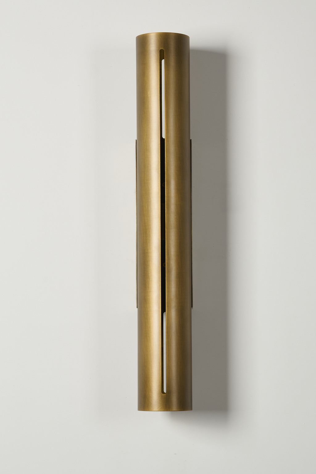 Long antique brass cylinder wall sconce, unlit front view