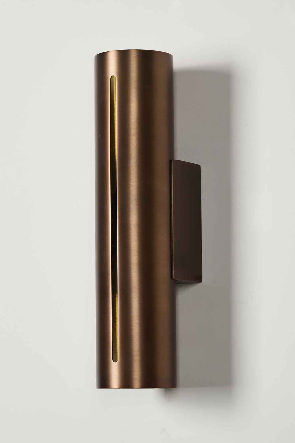 Short antique copper cylinder wall sconce, unlit front view with mounting plate