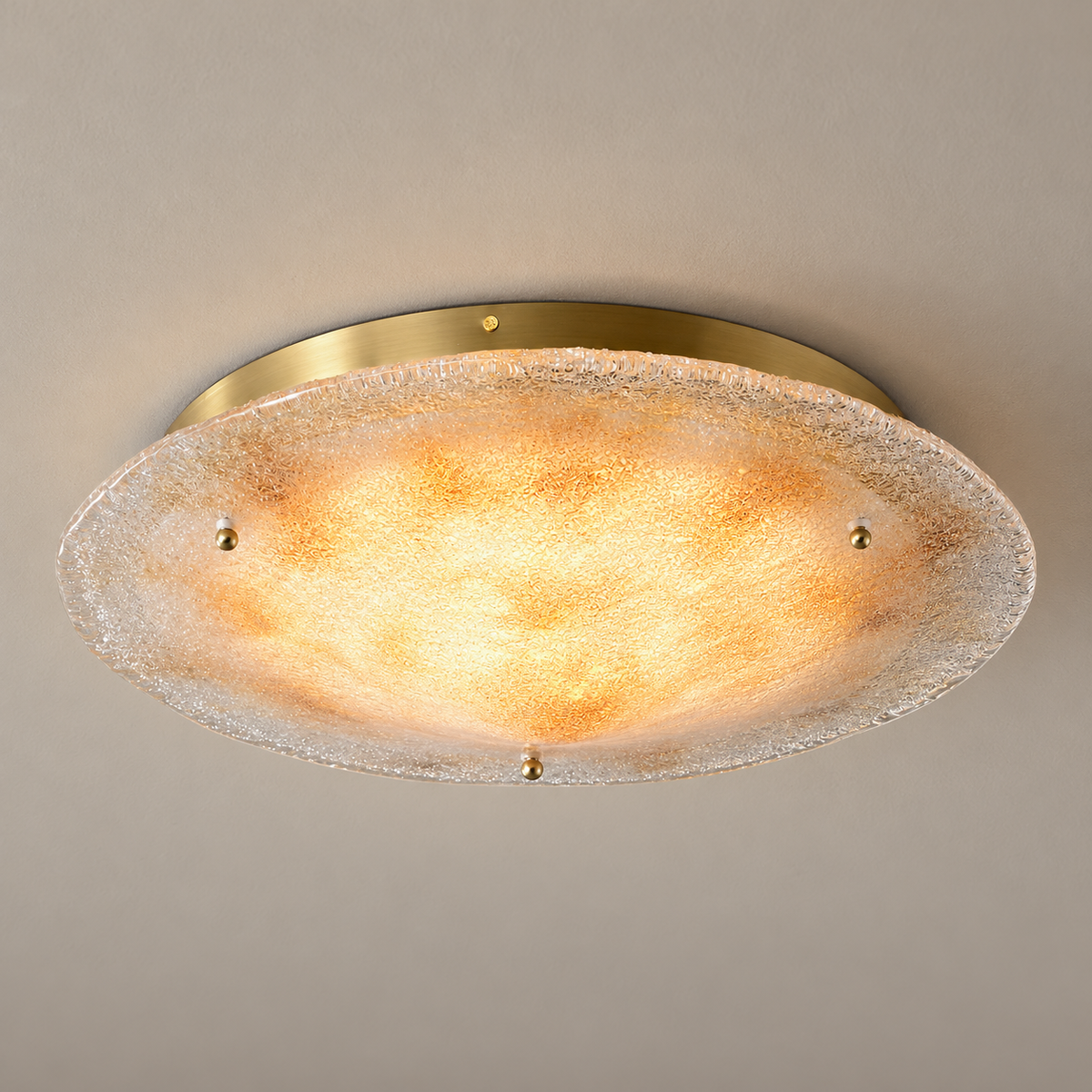 Gold hand-fired glass ceiling light — warm-lit complete fixture on a neutral ceiling