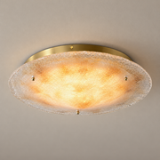 Gold hand-fired glass ceiling light — warm-lit complete fixture on a neutral ceiling