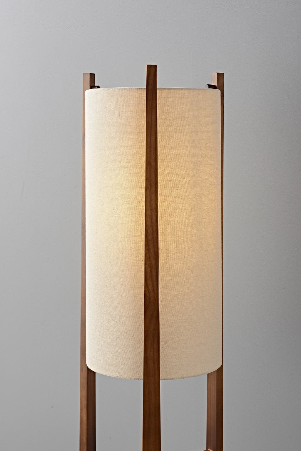 Ashverelle ash wood floor lamp — warm-lit fabric shade detail