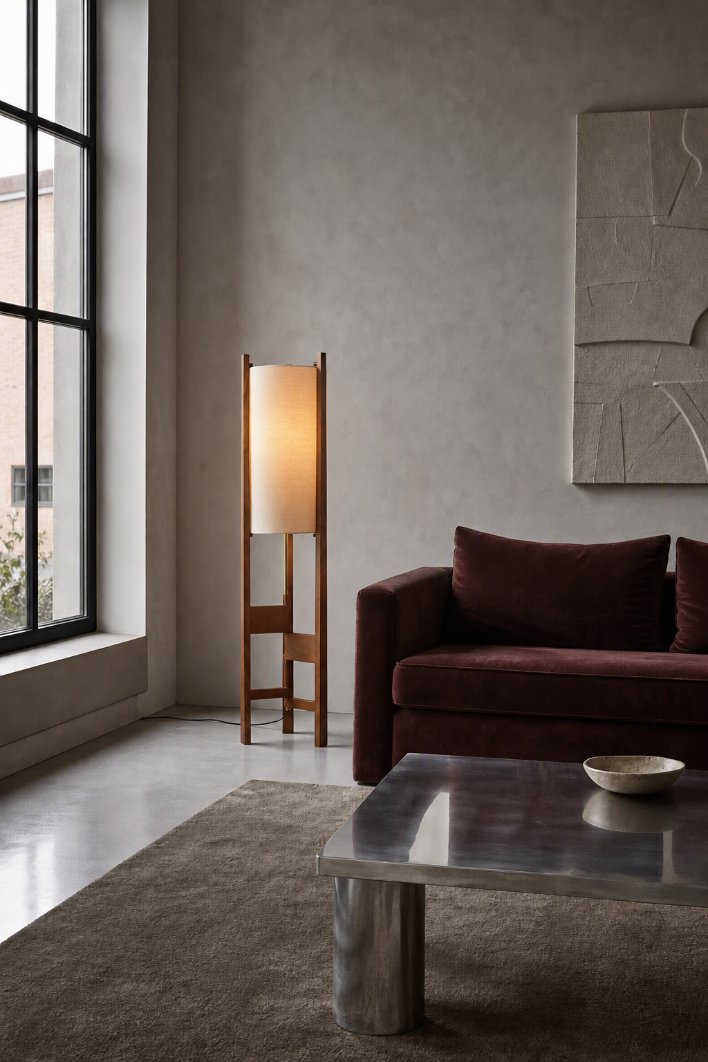 Ashverelle ash wood floor lamp — lounge setting, warm-lit lamp