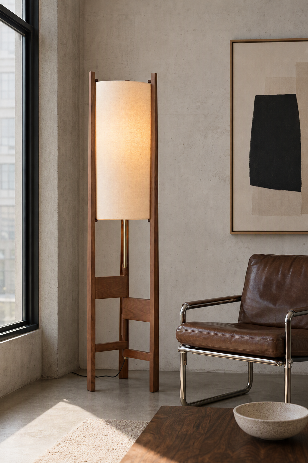 Ashverelle ash wood floor lamp — reading setting, warm-lit lamp