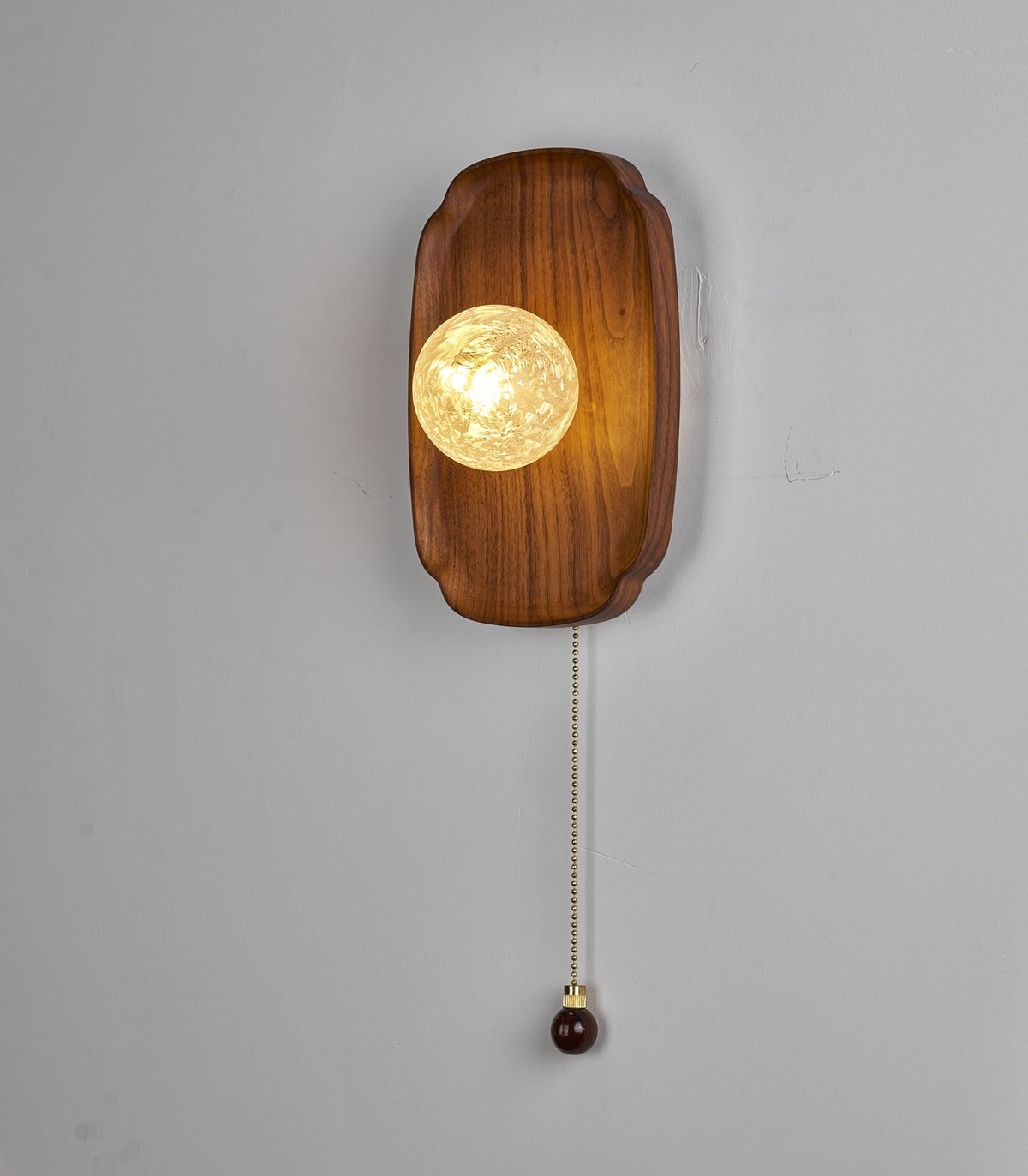 Rounded Walnut & Glass Wall Sconce actual photograph illuminated
