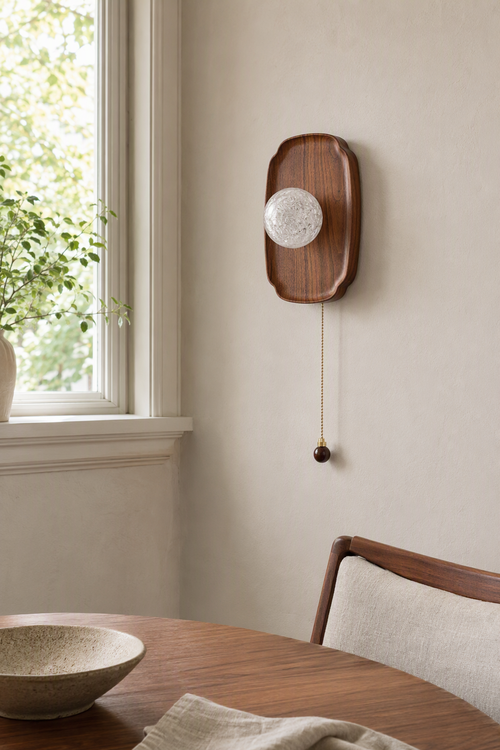 Rounded Walnut & Glass Wall Sconce switched off in a daylight room