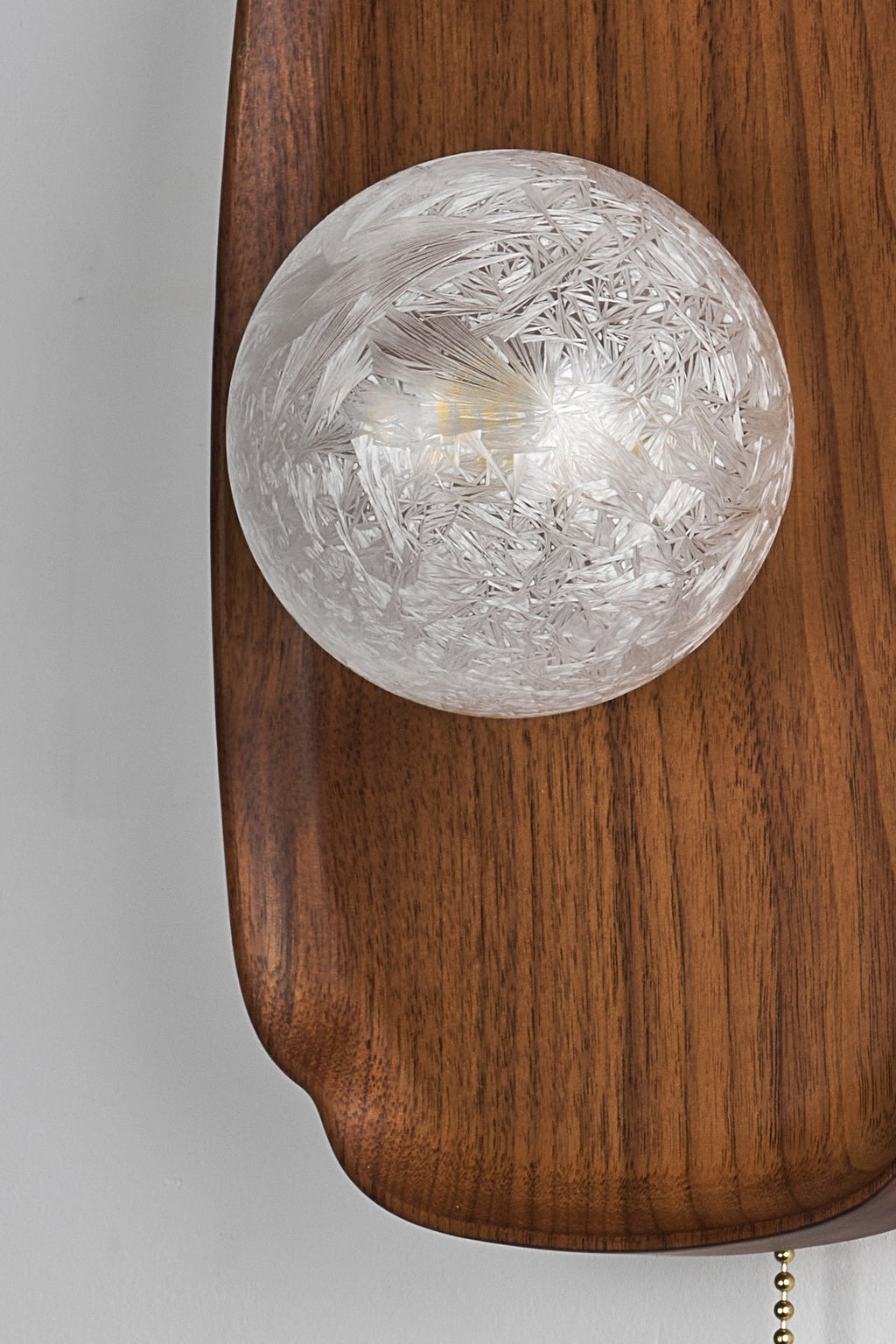 Rounded Walnut & Glass Wall Sconce close-up showing textured glass and walnut connection