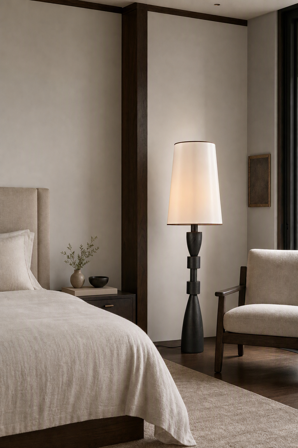 White-shaded camphor wood floor lamp beside a bed in a spacious bedroom