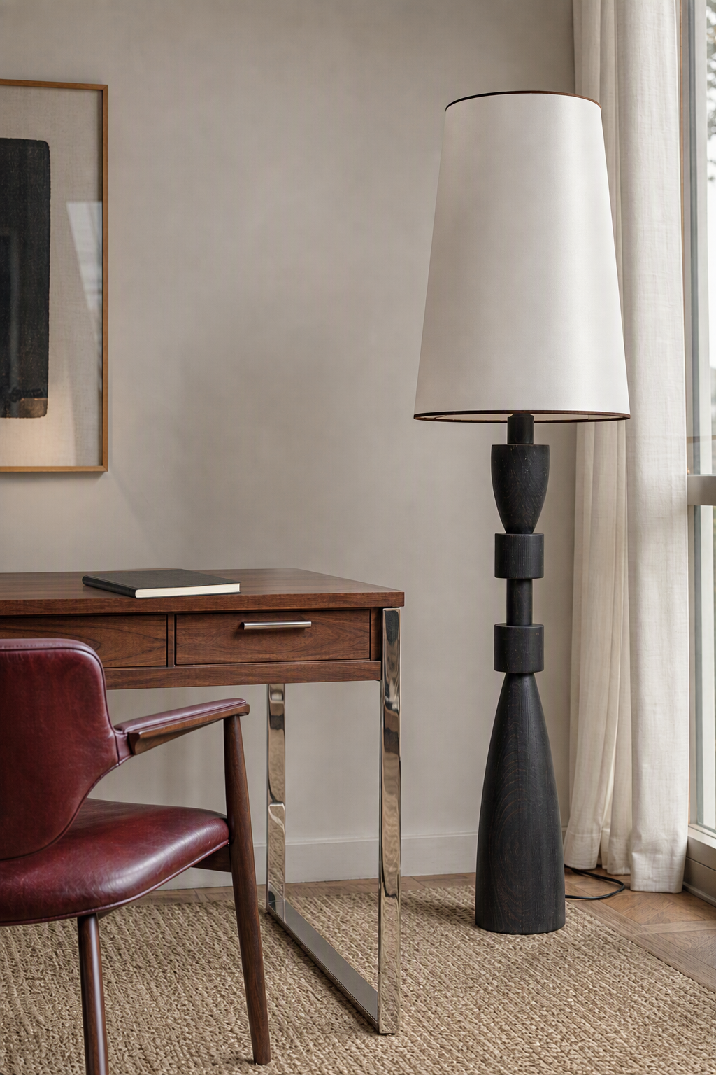 Unlit sculptural camphor wood floor lamp in a study with natural window light