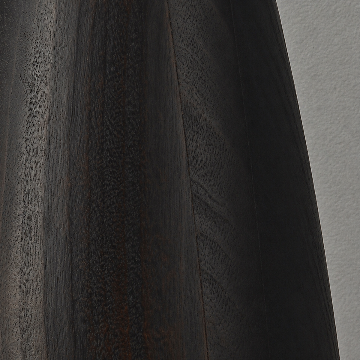 Close-up of the grain and texture of black-finished camphor wood