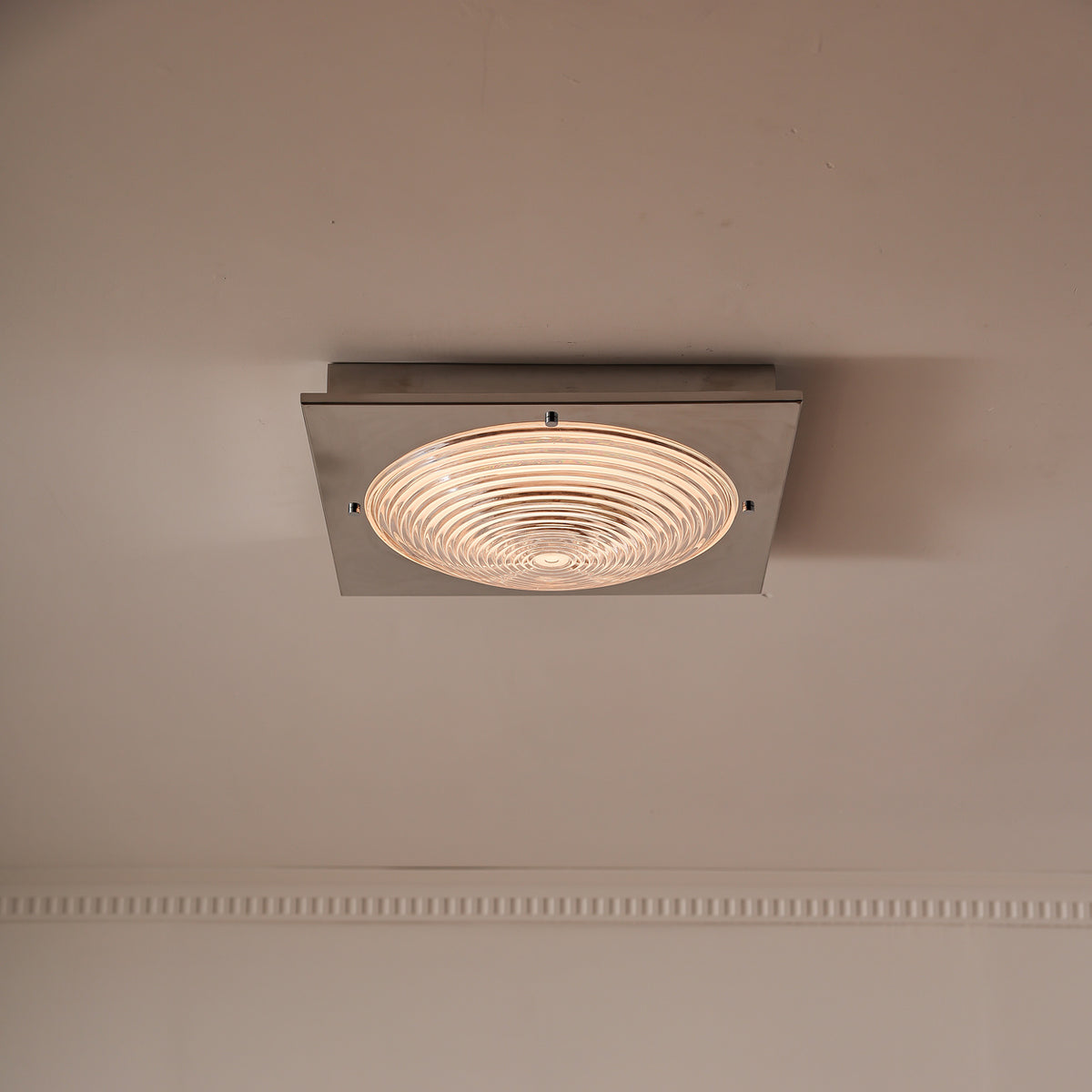 Real illuminated glass ceiling light with the plate front edge aligned horizontally
