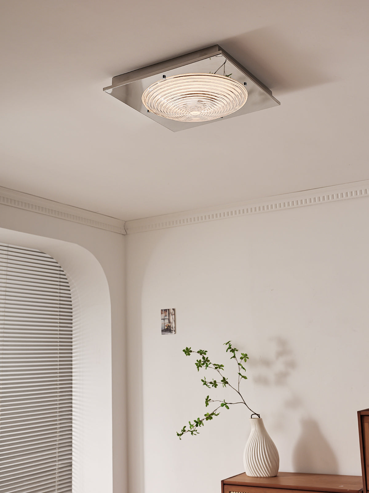 Illuminated glass ceiling light in a sitting area, original room photograph