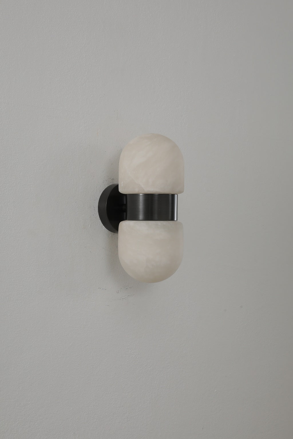 Alabaster Double Capsule Wall Sconce — Black with gold accents finish switched off, original product photograph
