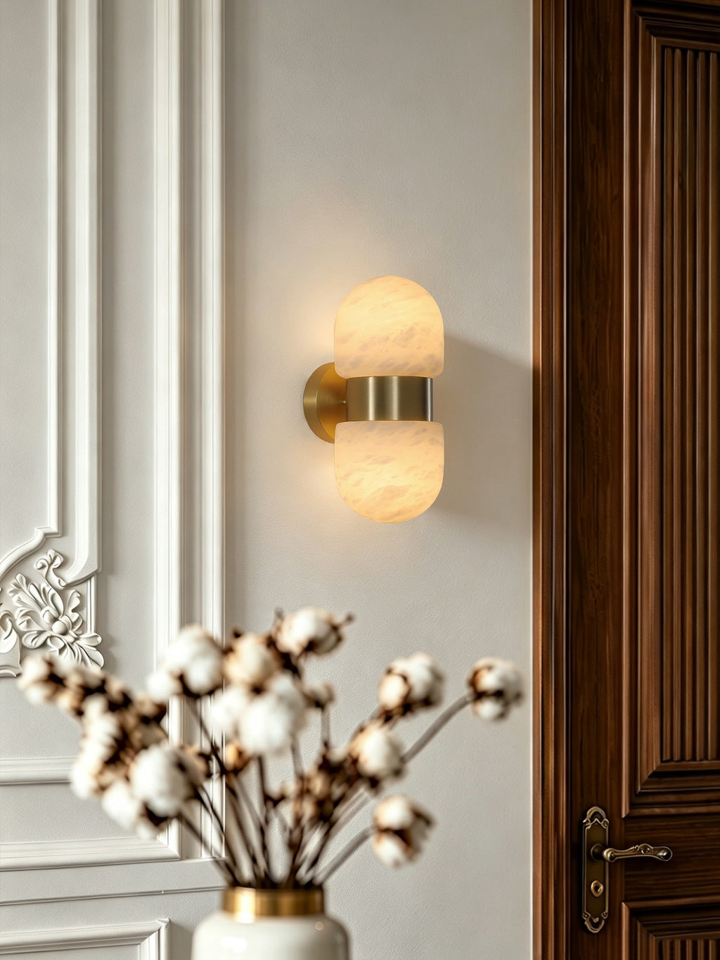 Alabaster Double Capsule Wall Sconce — Natural copper sconce beside an entry door