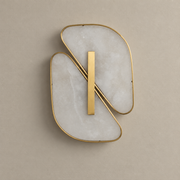 Unlit double-petal alabaster wall sconce with copper-color rims on a warm grey wall